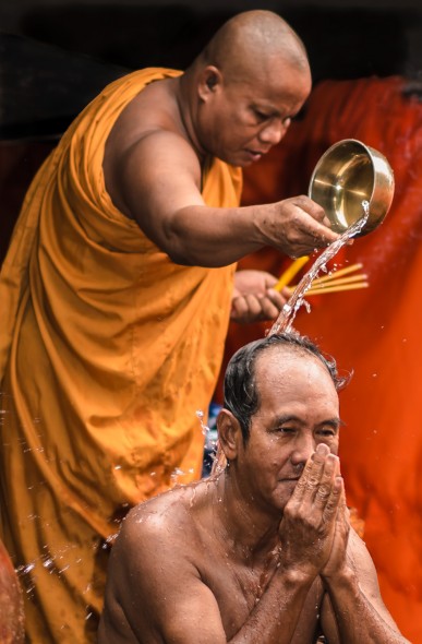 Dedicated flashguns have a greater power output, and many more adjustment options. A quick burst of flash outdoors can help to freeze the action, as with this Buddhist ceremony in Cambodia
